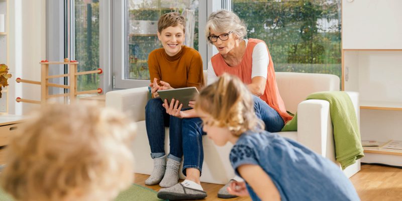 pre-school-teachers-with-tablet-looking-at-children-in-kindergarten.jpg